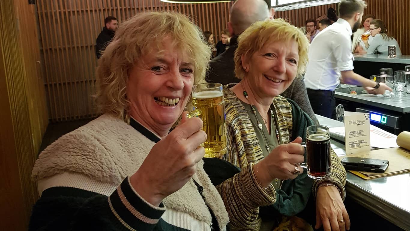 Two happy women having a drink in a bar
