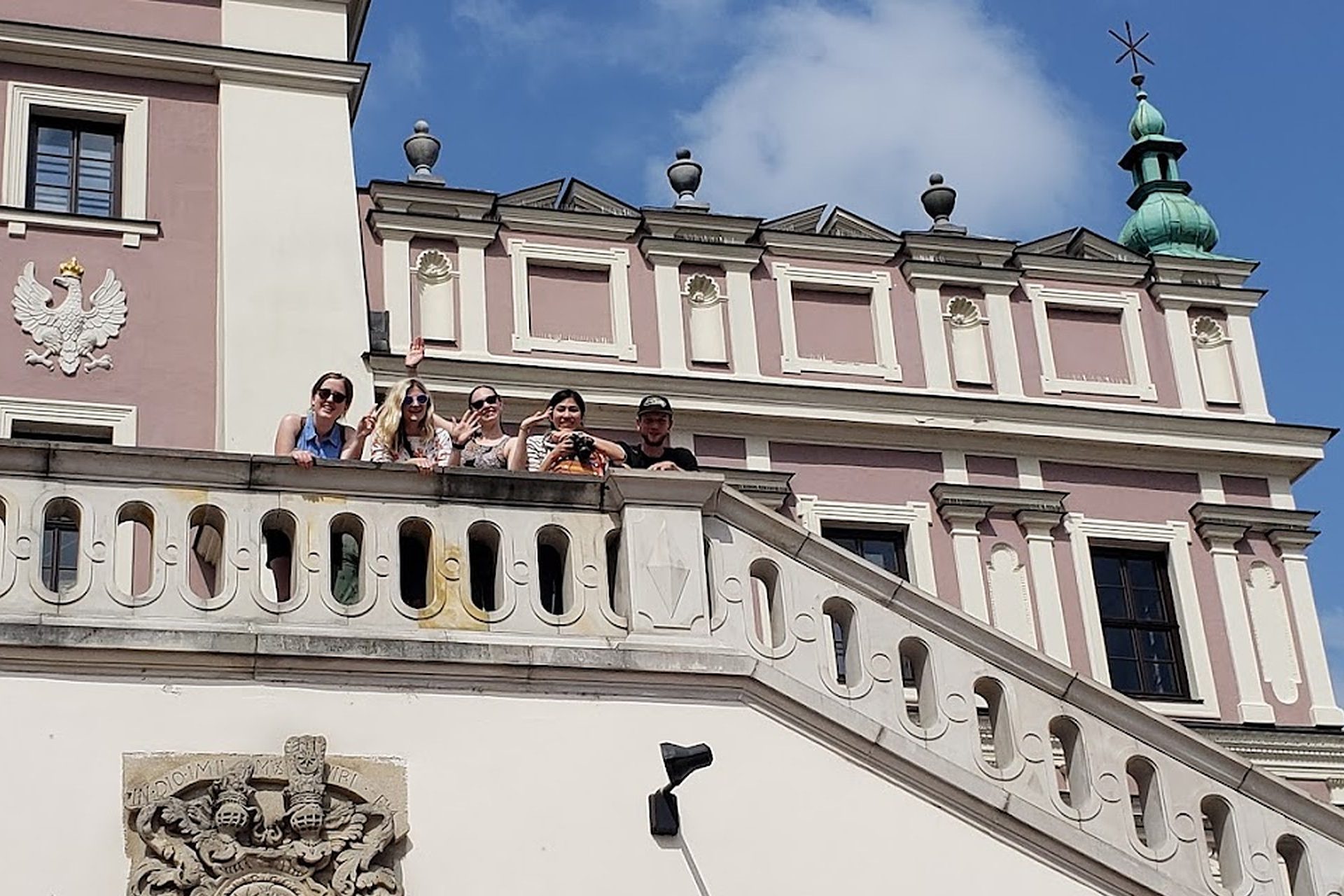 Martin's City Tours, a group of tourists at the stairs of Zamość's Town Hall.